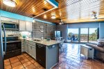 open concept living space, saltillo tile, wood ceilings, bay windows